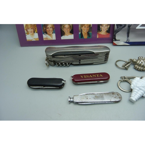 876 - A collection of penknives a Higear utility knife, three keyrings, Princess Diana stamps, a £5 2012 c... 