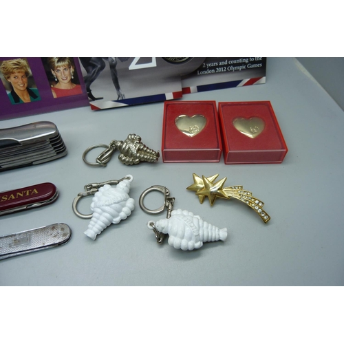 876 - A collection of penknives a Higear utility knife, three keyrings, Princess Diana stamps, a £5 2012 c... 