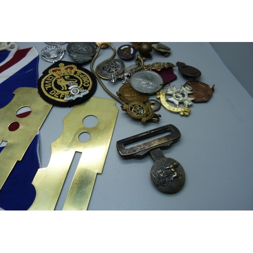 892 - Military items including a WWI wound badge numbered B122143, other badges and medallions, brass unif... 