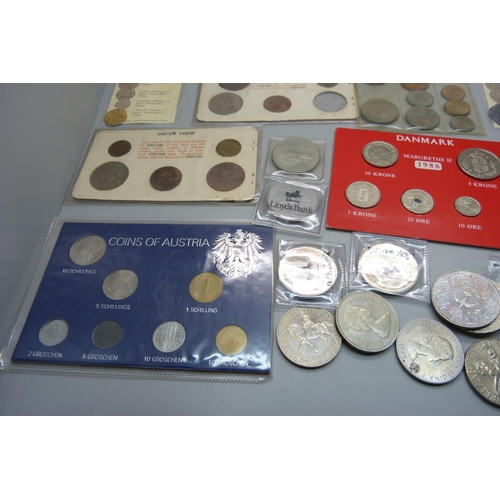 893 - A collection of coins and coin sets including two reproduction Armada coins, crowns, etc.