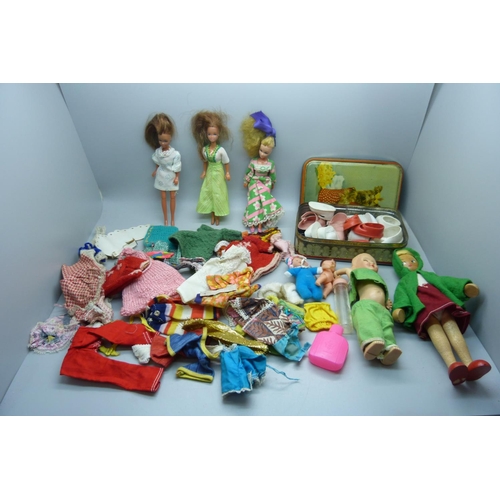 909 - Pippa dolls and clothes, a Rosebud doll, other dolls and a collection of shoes for larger dolls