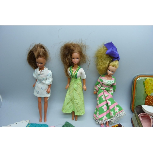 909 - Pippa dolls and clothes, a Rosebud doll, other dolls and a collection of shoes for larger dolls