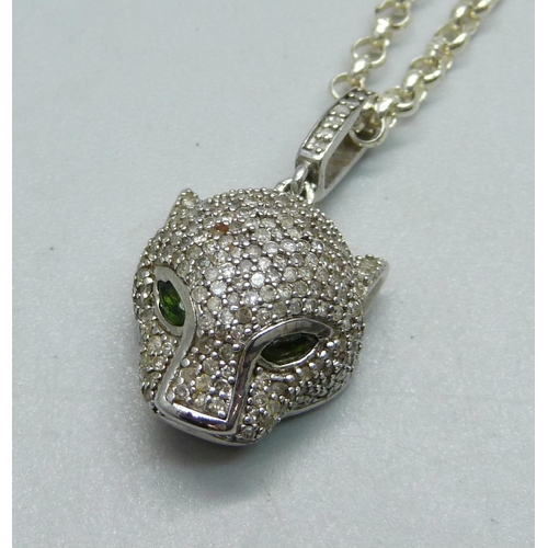 922 - A silver panther pendant with green stone eyes