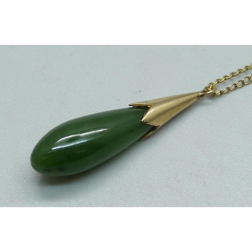 923 - A jade pendant and on a 14ct gold chain, chain 0.6g