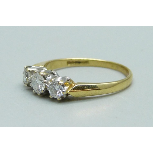 933 - An 18ct gold, three stone diamond ring, 2.3g, L