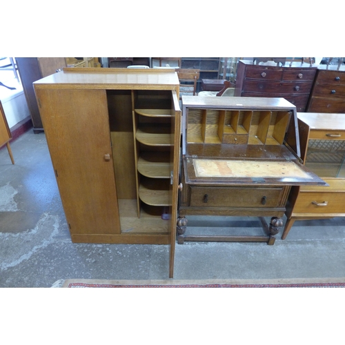 105 - A Jacobean Revival carved oak bureau and an Art Deco oak tallboy