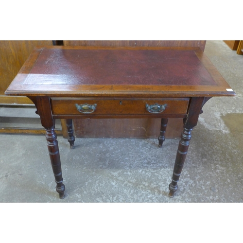 105A - A Victorian walnut single drawer writing table