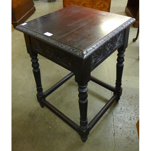 110 - A late Victorian carved oak occasional table