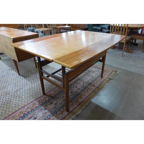 12 - A Danish teak metamorphic dining/coffee table