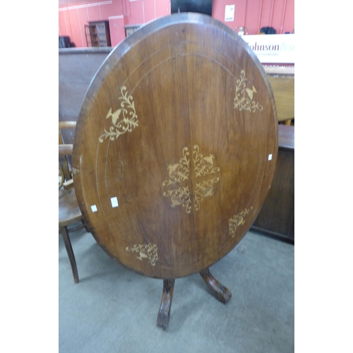 130 - A Victorian inlaid walnut oval tilt-top loo table