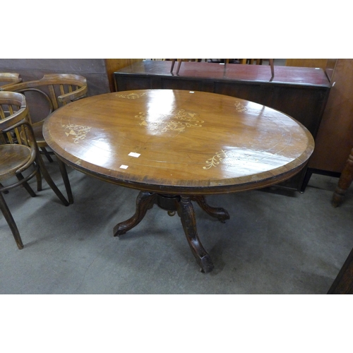 130 - A Victorian inlaid walnut oval tilt-top loo table