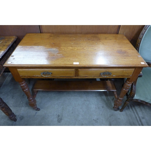 134 - A Victorian Aesthetic Movement pine two drawer writing table