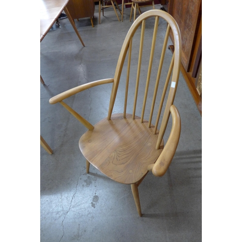 16 - An Ercol Blonde elm and beech Grand Windsor extending dining table and eight Ercol Blonde Quaker mod... 