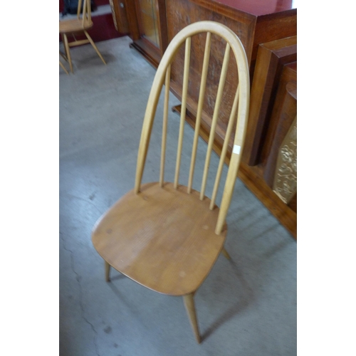 16 - An Ercol Blonde elm and beech Grand Windsor extending dining table and eight Ercol Blonde Quaker mod... 