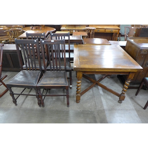 176 - An early 20th Century oak six piece dining suite, comprising; draw-leaf table, four chairs and a sid... 