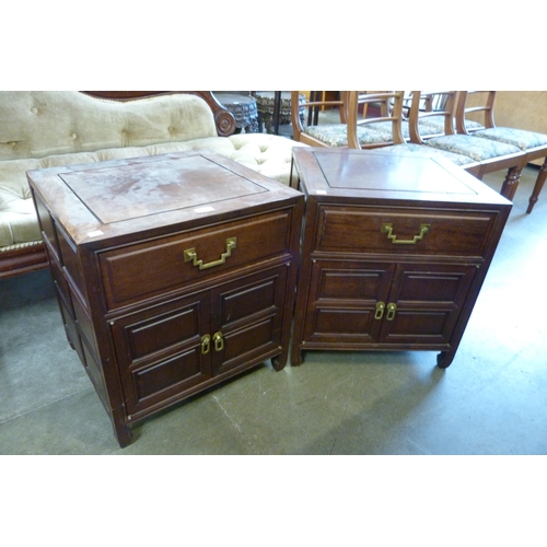 180 - A pair of oriental carved hardwood bedside chests