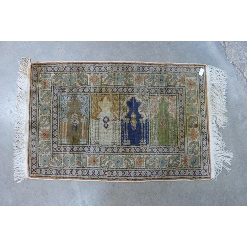 196 - A small vintage Afghan beige ground rug, 64 x 99cms