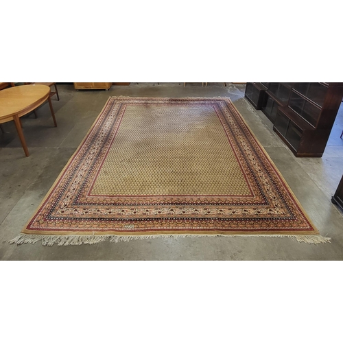 198A - A large beige ground  rug, 301 x 393cms