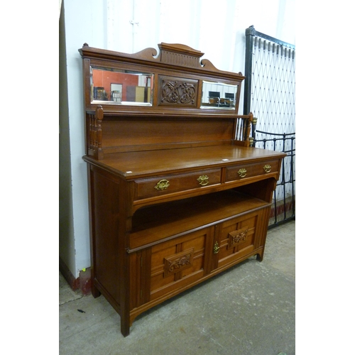 200 - A Victorian Aesthetic Movement carved walnut sideboard