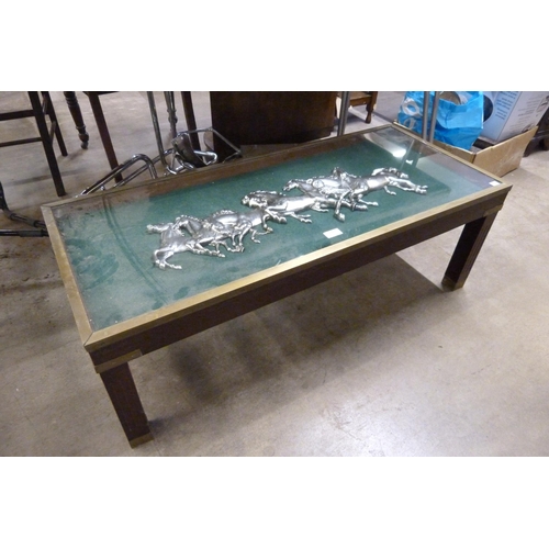 202 - A mahogany and brass mounted coffee table, the top inset with galloping horses