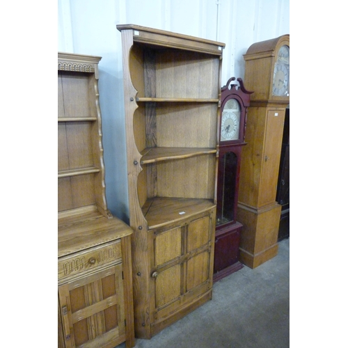 207 - An Ercol Golden Dawn elm corner cupboard