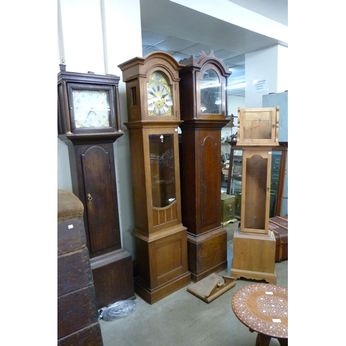 209 - Two oak longcase clocks, an oak longcase clock case and a pine longcase clock case