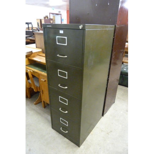 218 - An industrial green metal four drawer filing cabinet