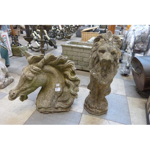 242 - A concrete garden figure of a lion and a horse head