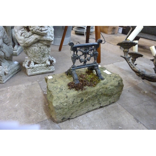 253 - An early 20th Century cast iron boot scraper, on stone base