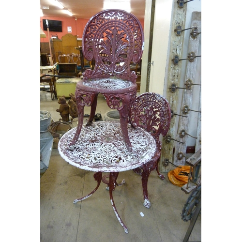 259 - A cast alloy garden table and two chairs