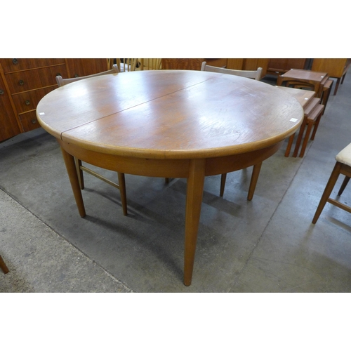 26 - A G-Plan teak extending dining table and four chairs