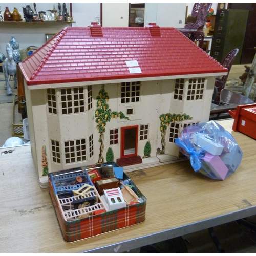 269 - A doll's house, with sliding tin plate front, with some furniture