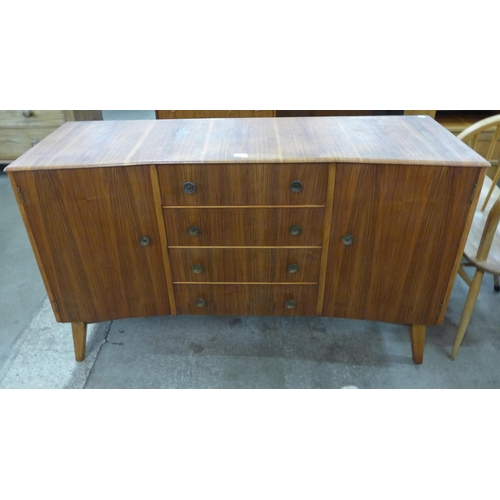 27 - An afromosia concave sideboard