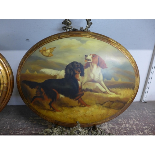 277 - A pair of oval oleographs depicting dogs, with Italian style brass table top easels