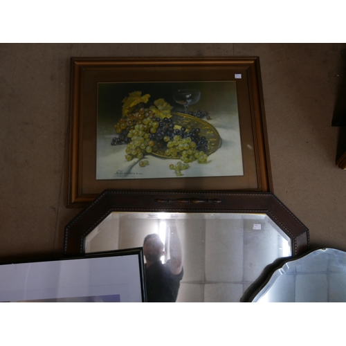 304 - A carved oak mirror, a bevelled edge mirror and two prints