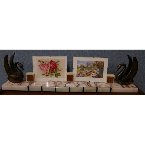 306 - An Art Deco onyx and marble double photograph frame, ,mounted with spelter swans