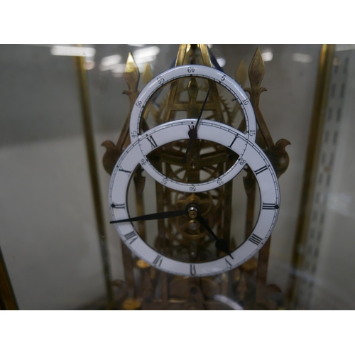 308 - A cased brass fusee skeleton clock