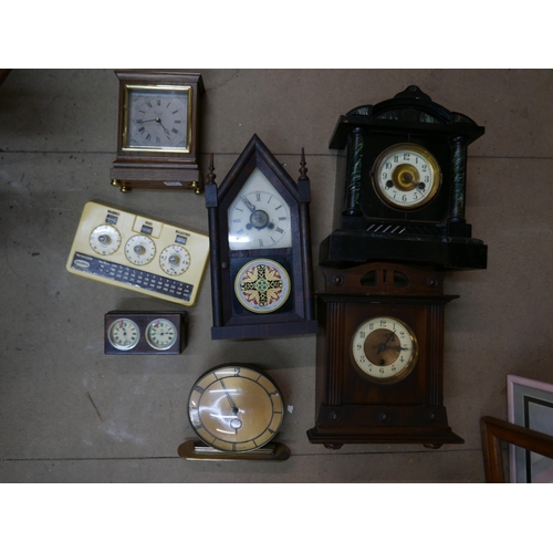 324 - Five mantel clocks, a vintage Metricock weight converter, another timepiece and a cast metal wine ra... 