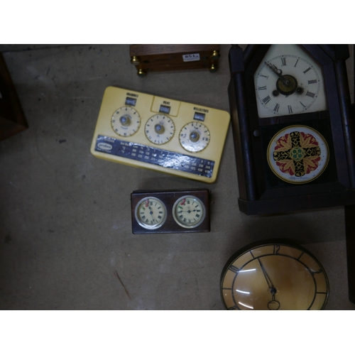 324 - Five mantel clocks, a vintage Metricock weight converter, another timepiece and a cast metal wine ra... 