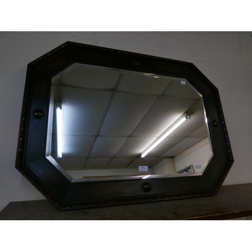 328 - A carved oak octagonal framed mirror