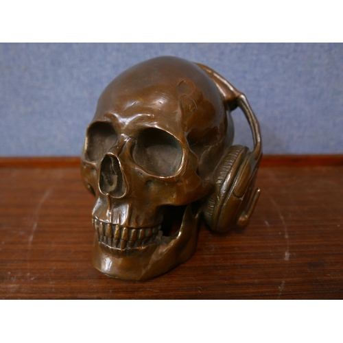 335 - A bronze skull wearing headphones