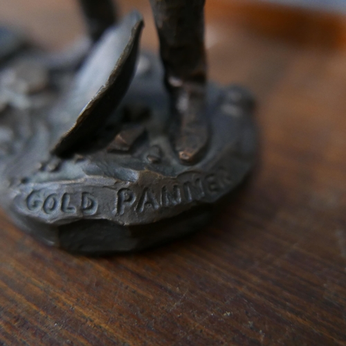 348 - A pair of similar bronze figures of cowboys