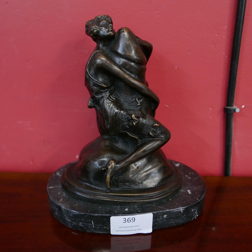 369 - An erotic bronze figure of a female, on black marble socle