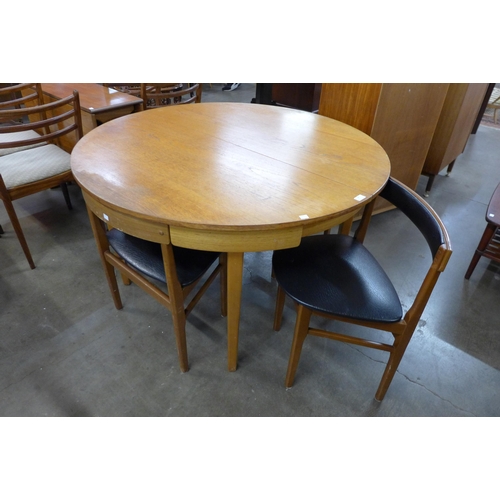 44 - A teak extending dining table and four chairs