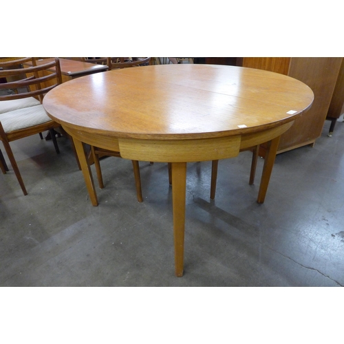 44 - A teak extending dining table and four chairs