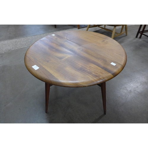 59 - An Ercol elm and beech drop-leaf coffee table