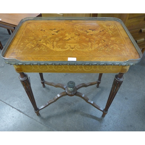 75 - A French Louis XV style marquetry inlaid and gilt metal mounted single drawer gueridon writing table