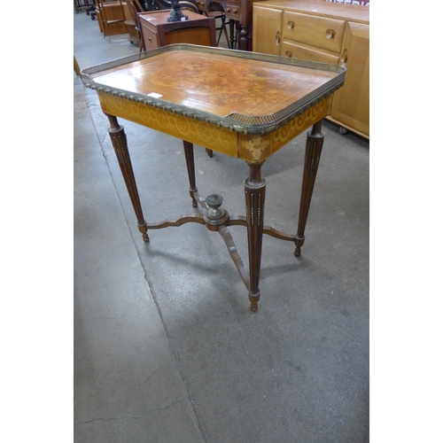 75 - A French Louis XV style marquetry inlaid and gilt metal mounted single drawer gueridon writing table