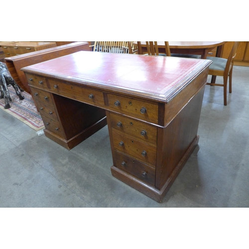 76 - An early 20th Century oak and red leather topped desk