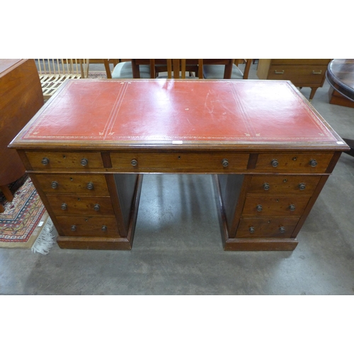 76 - An early 20th Century oak and red leather topped desk